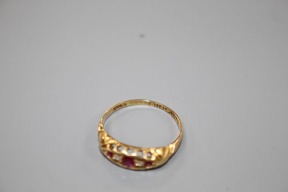 A George V 18ct gold, three stone ruby and two stone diamond set half hoop ring, size P, gross weight 1.9 grams.